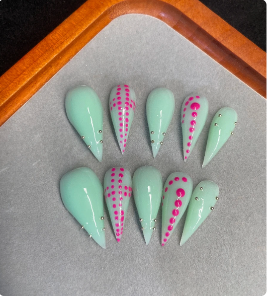 Mint green stiletto press-on nails with pink dot design